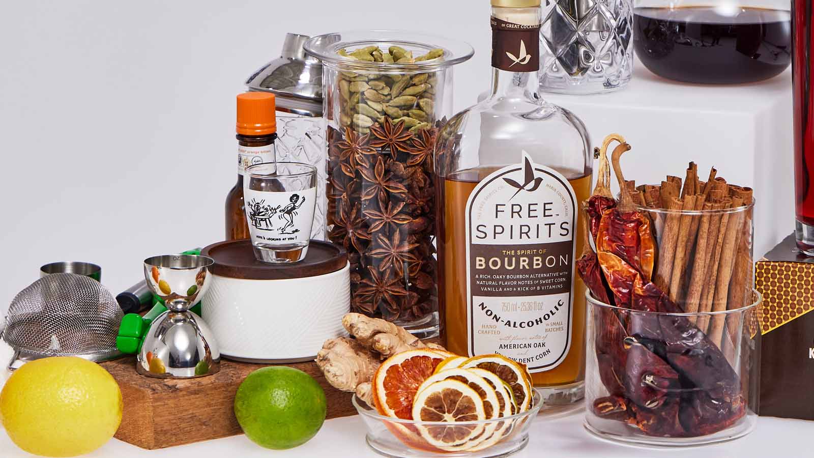 Bar tools, citrus, garnishes and a Free Spirits bottle on a bar top