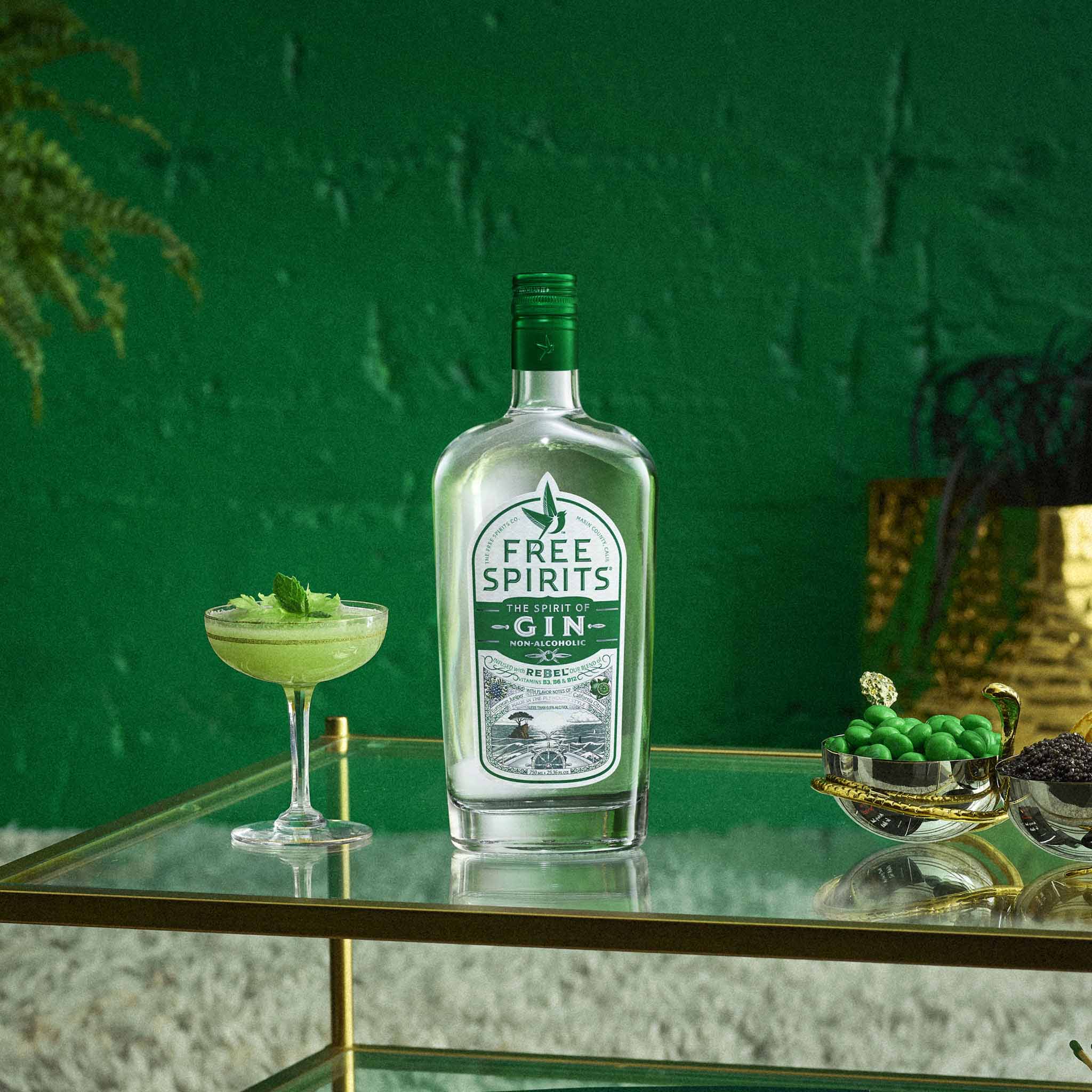 Bottle of Free Spirits gin on a table with a green background