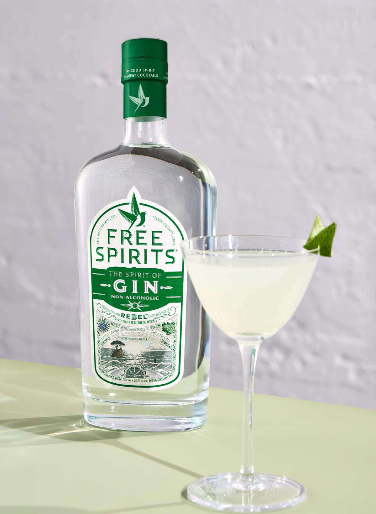 A bottle of Free Spirits and a cocktail on a table