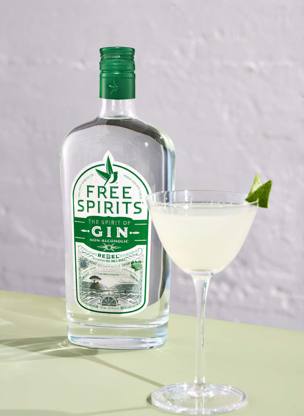 A bottle of Free Spirits and a cocktail on a table