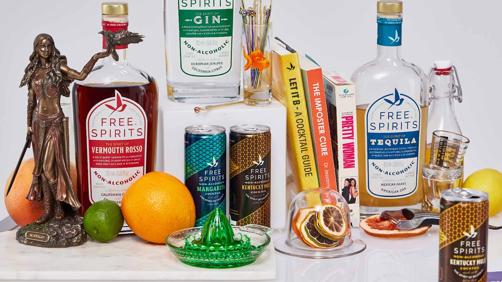 Bottles and cans of Free Spirits with bar tools and a book about b-vitamins and cocktails