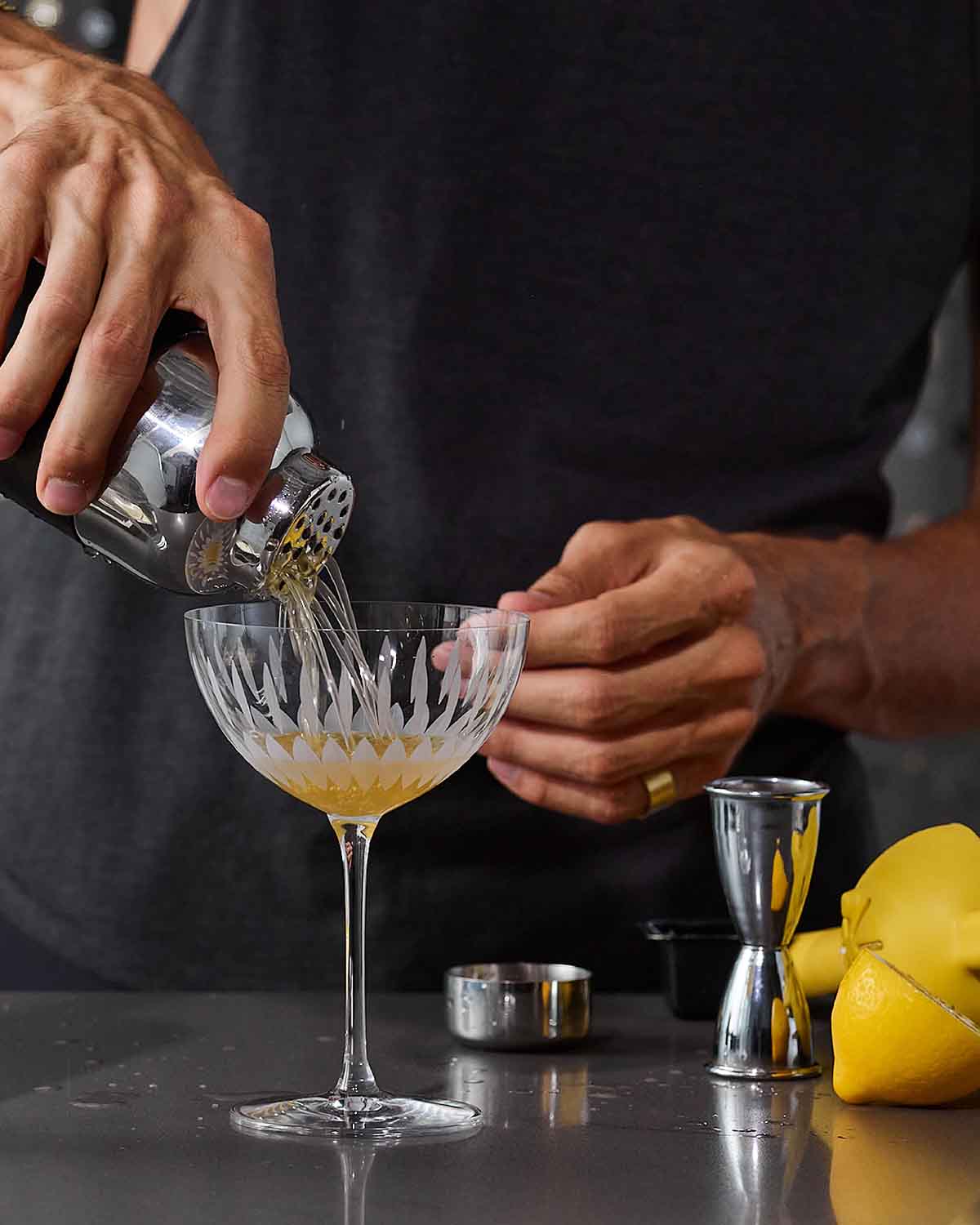 A bartender making a gin cocktail