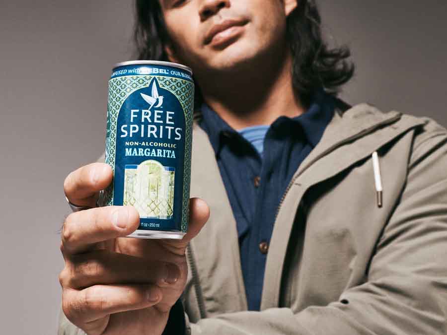 Person holding a can of Free Spirits Margarita non-alcoholic drink.