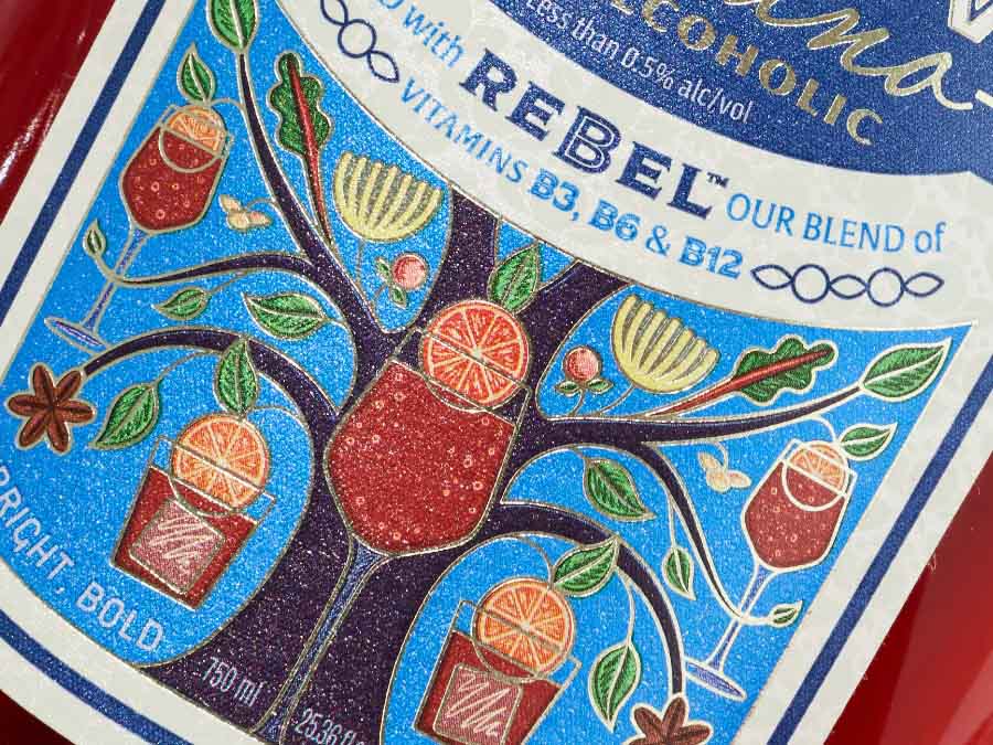 Decorative label with colorful illustrations and text on a bottle.
