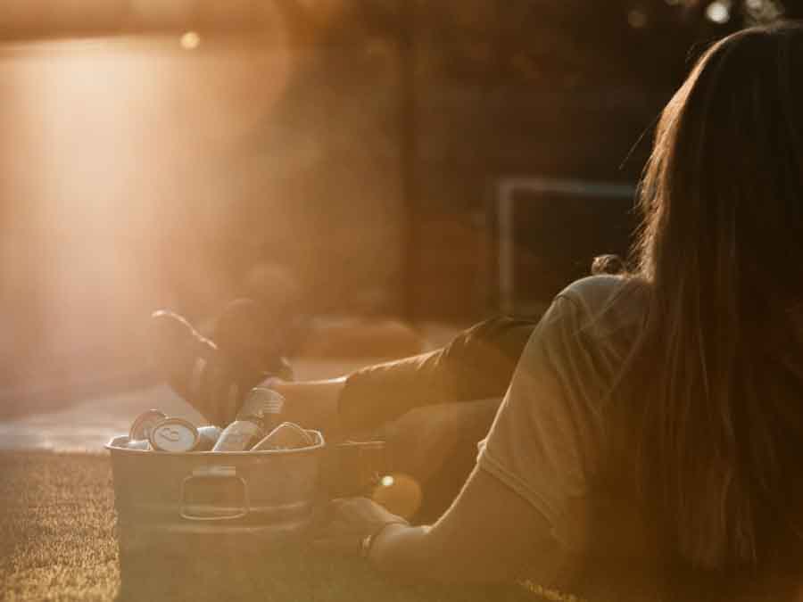 Person watching the sunset with a metal container of Free Spirits RTDs