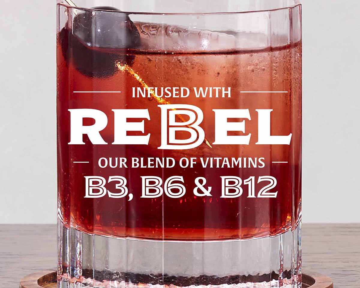 Boulevardier cocktail and 'REBEL' branding on a light background