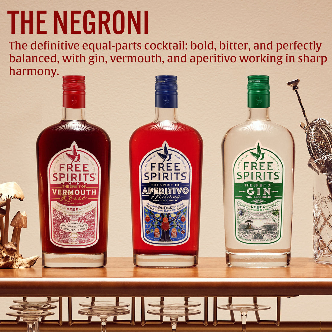 Three bottles of Free Spirits Vermouth, Aperitivo, and Gin on a bar shelf with text about The Negroni cocktail.