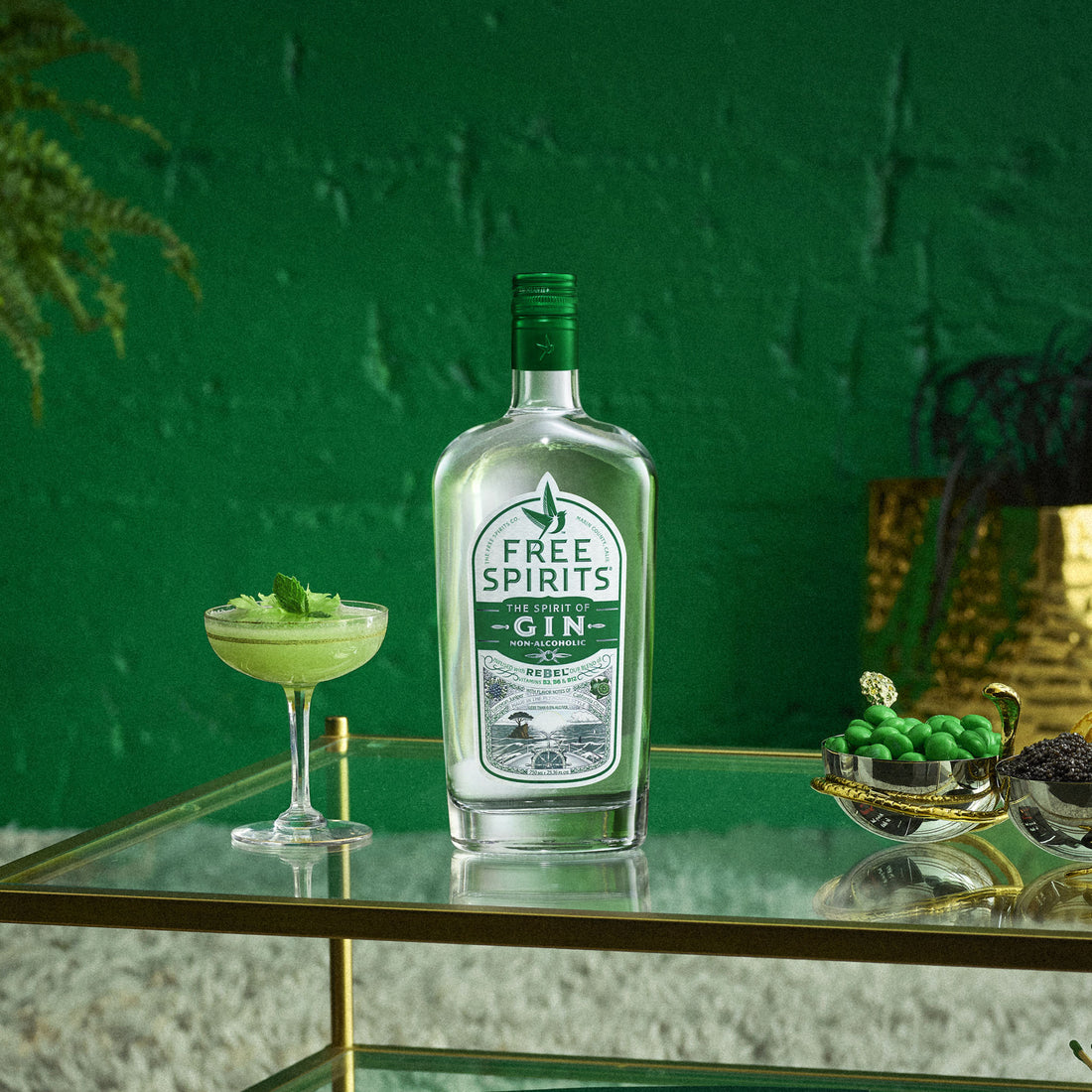 Bottle of Free Spirits gin on a table with a green background